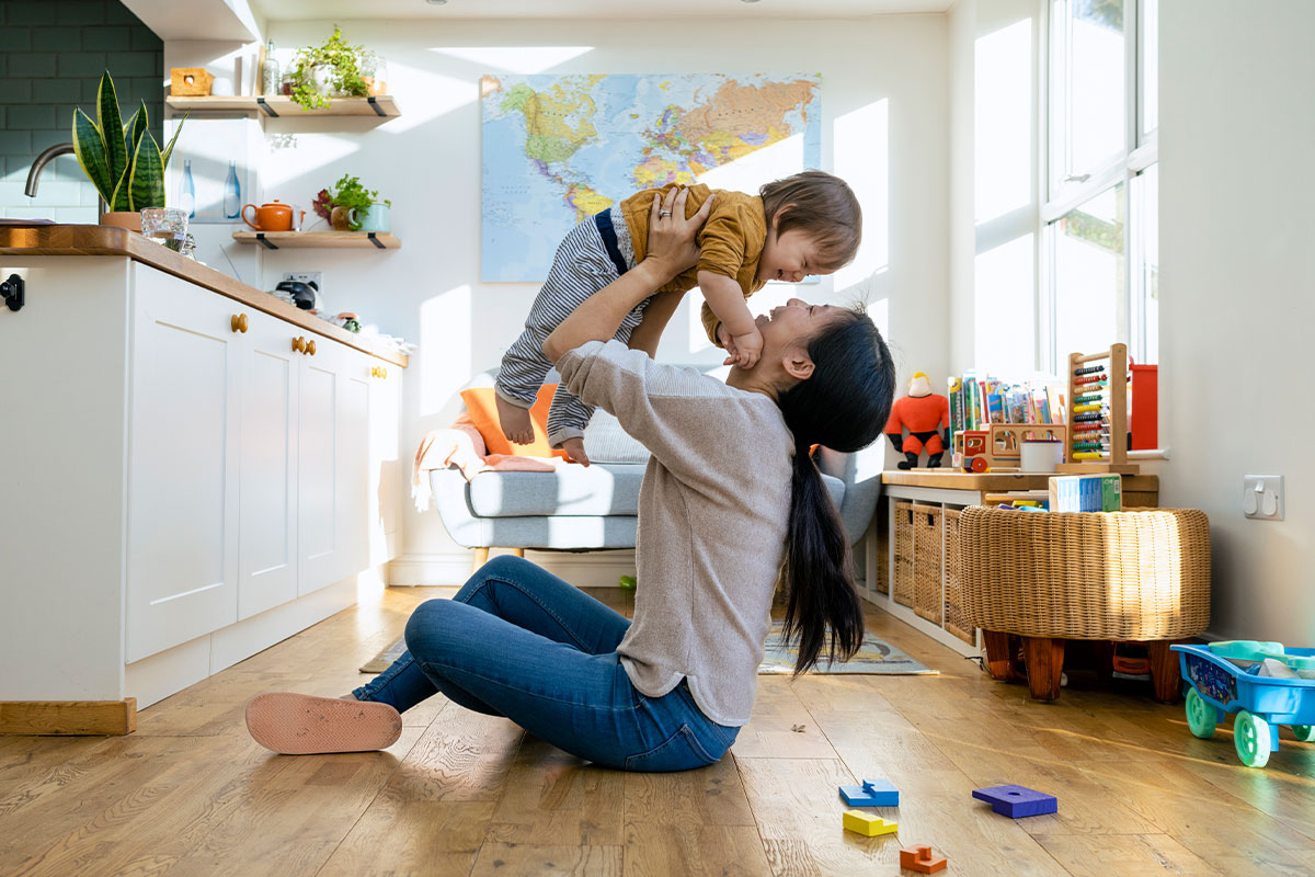 Mom playing with baby, using Dr. Tim Vogel for arteriorvenous malformations in Totowa
