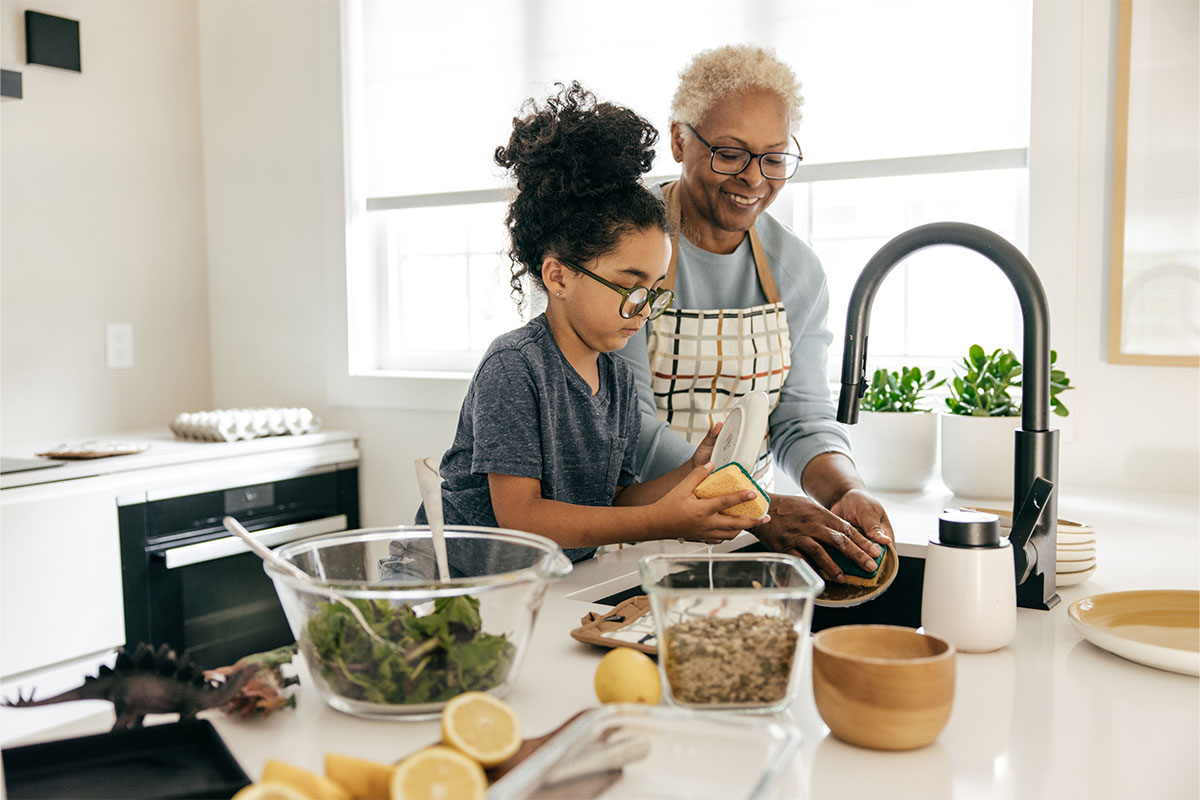Child cooking with adult after treatment for arteriorvenous malformation in Totowa